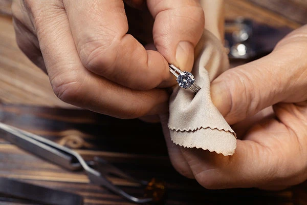 jewelry repair man cleaning a diamond ring