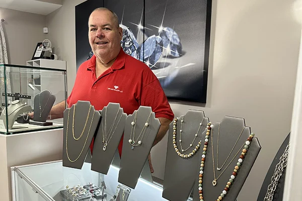 Don Walsh standing behind the counter in his shop